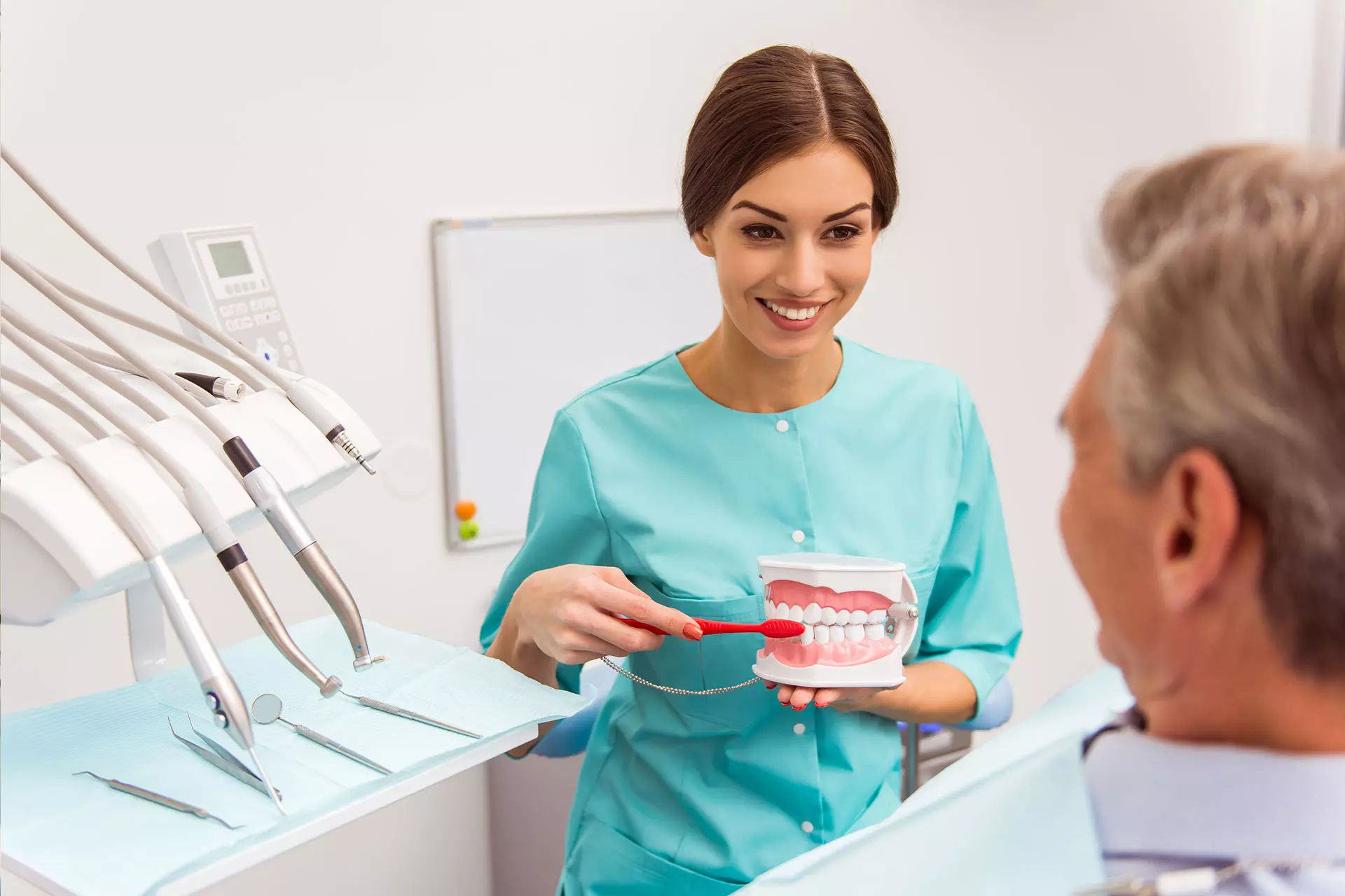 Home 4 Dentist explaining dentures to an older patient