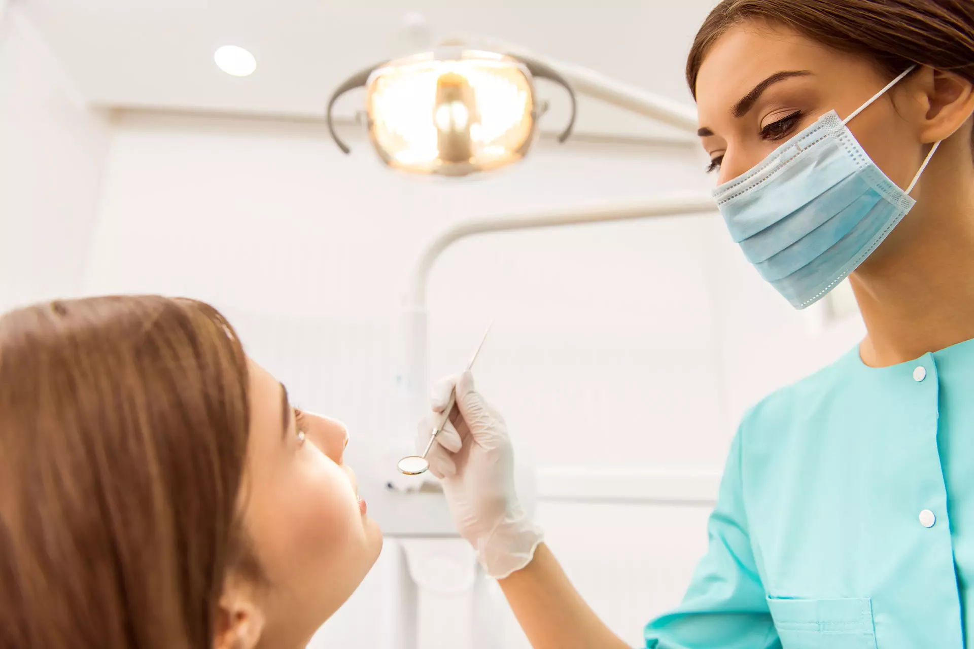 Home 5 Dentist examining a patient