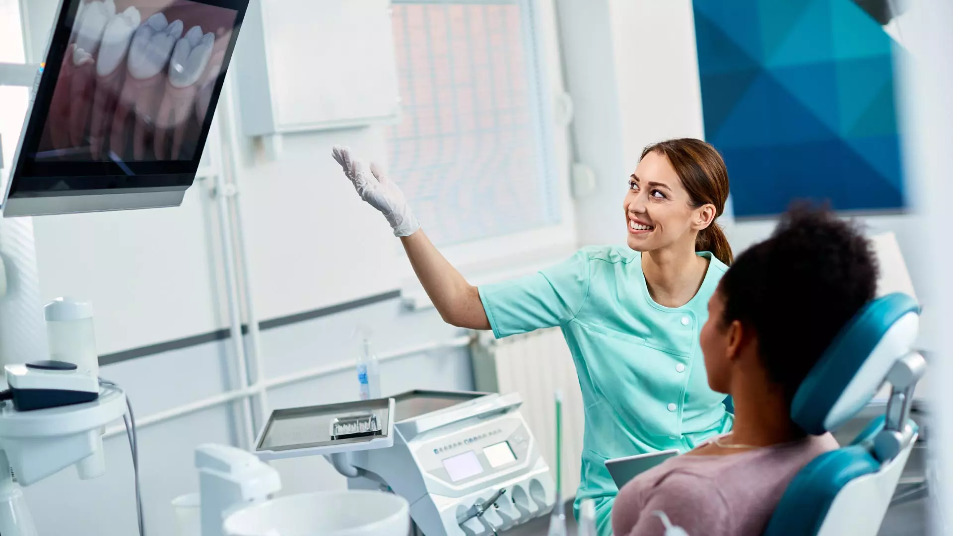 Home 8 Dentist reviewing a panoramic X-ray with a patient